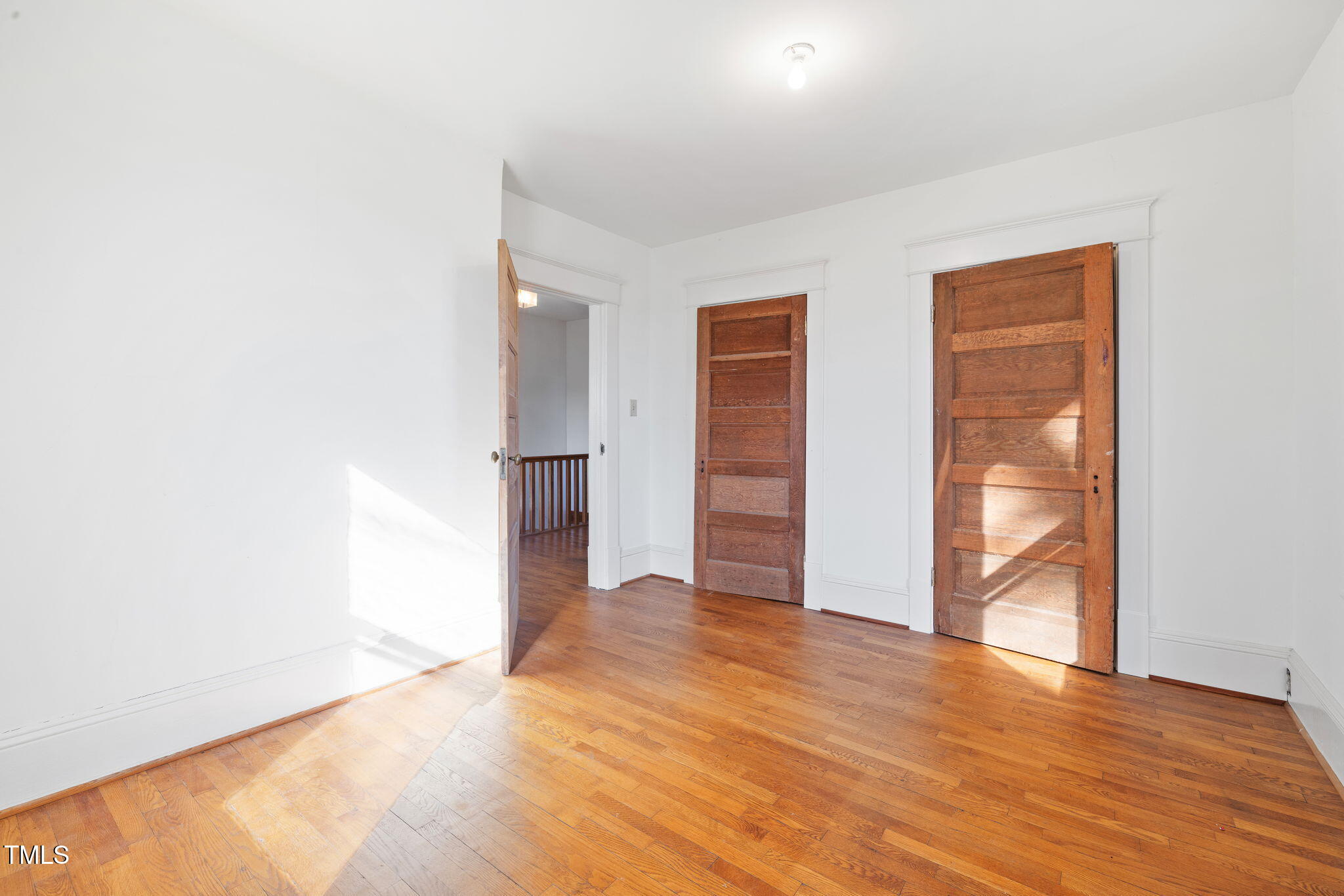 520 Polk Street Raleigh, NC 27604 - Photo 20 of 36 a view of an empty room with wooden floor and a window
