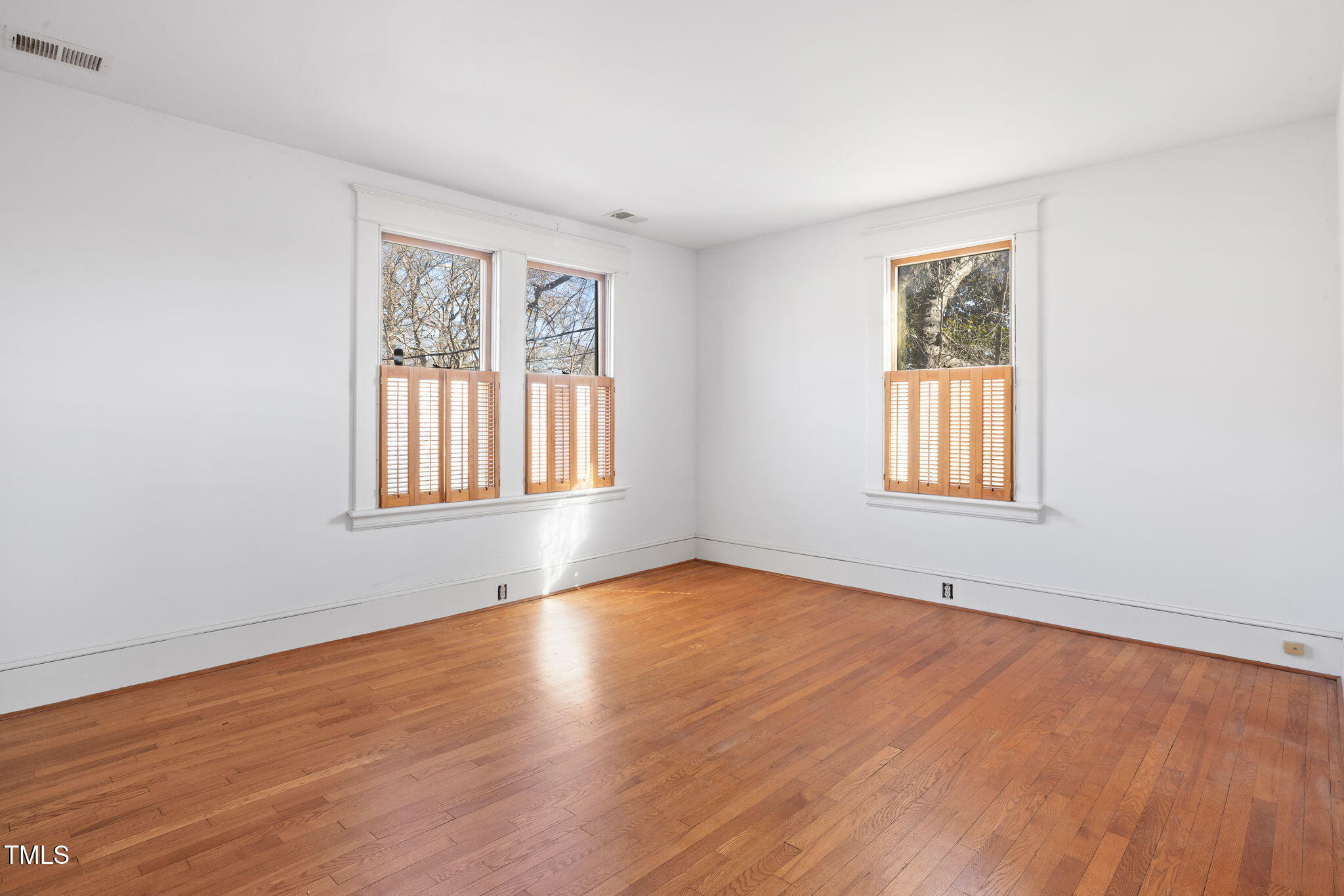 520 Polk Street Raleigh, NC 27604 - Photo 22 of 36 a view of an empty room with wooden floor and a window
