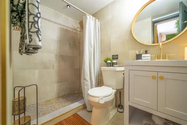 a kitchen with stainless steel appliances a large window and a refrigerator