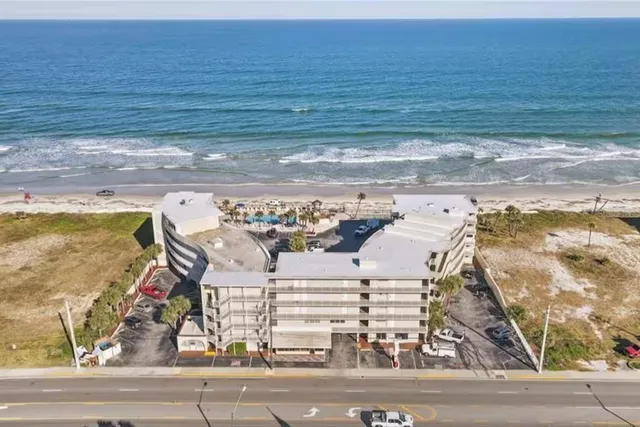 a view of a dry yard with wooden fence