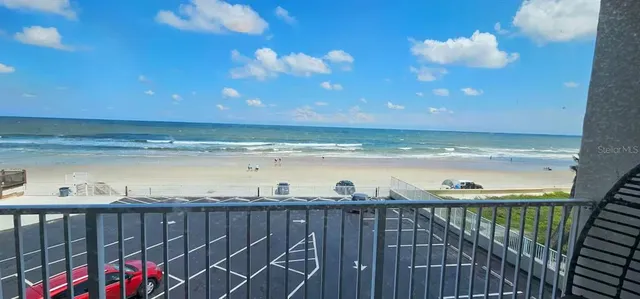 a row of palm trees on the side of a street