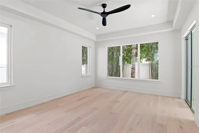 a view of a room with a window and a ceiling fan