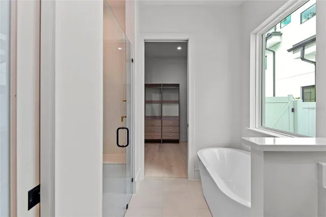 a bathroom with a tub and a window