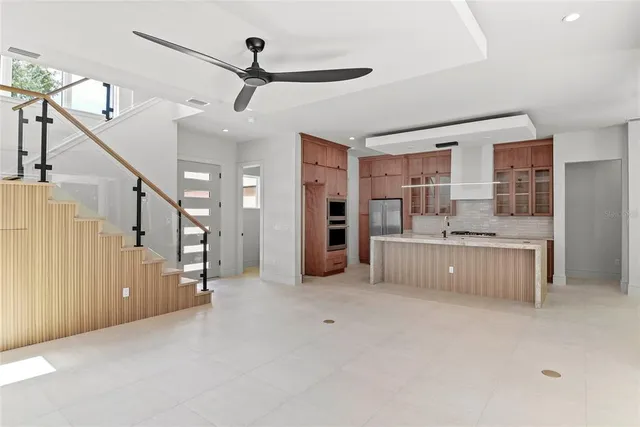 a view of a kitchen with refrigerator and cabinets