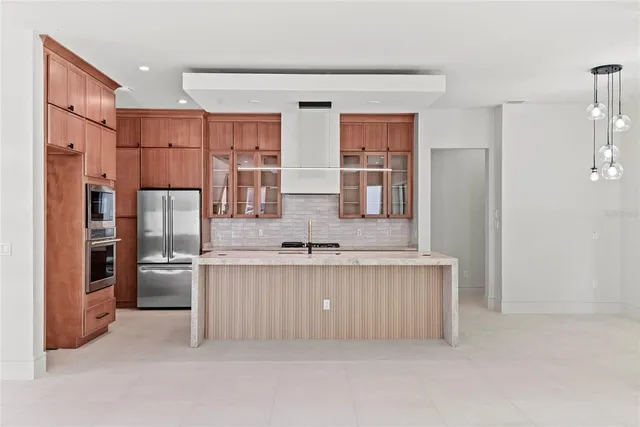 a kitchen with stainless steel appliances granite countertop a refrigerator and a sink