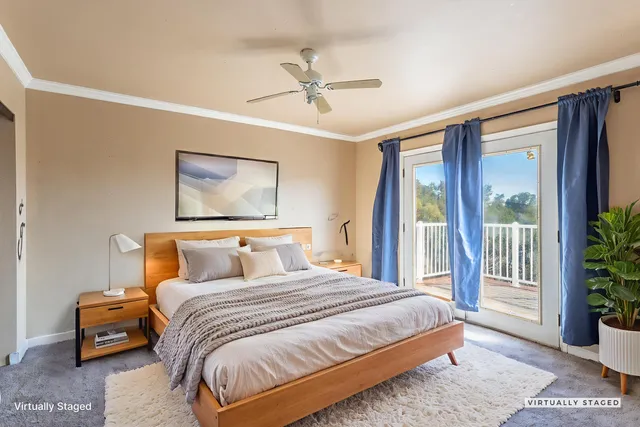 a bedroom with a large bed and a potted plant