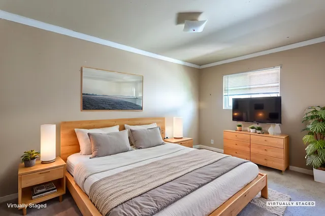 a bedroom with a bed and a flat screen tv