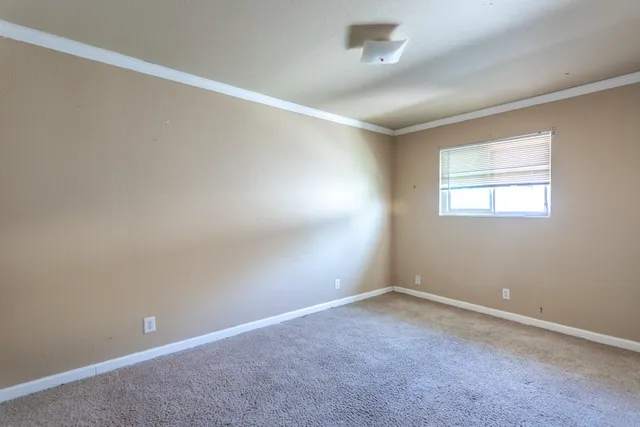 an empty room with a empty space and windows