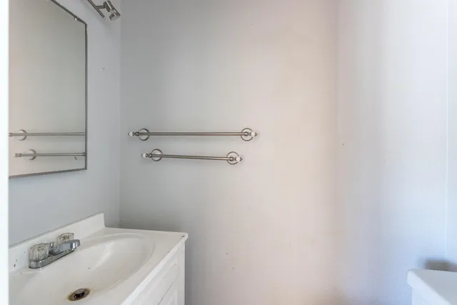 a bathroom with a sink and mirror