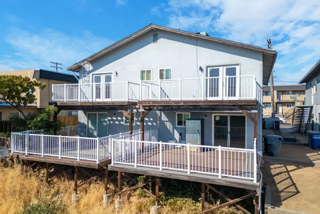 a view of a house with wooden deck