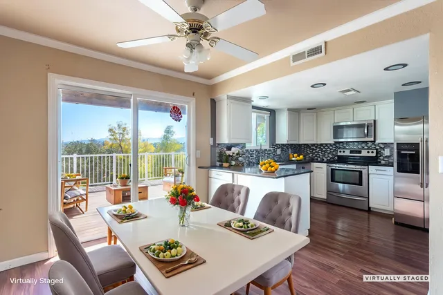 a view of kitchen with a table and chairs