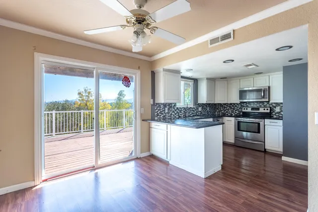 a kitchen with stainless steel appliances granite countertop a stove top oven and a refrigerator