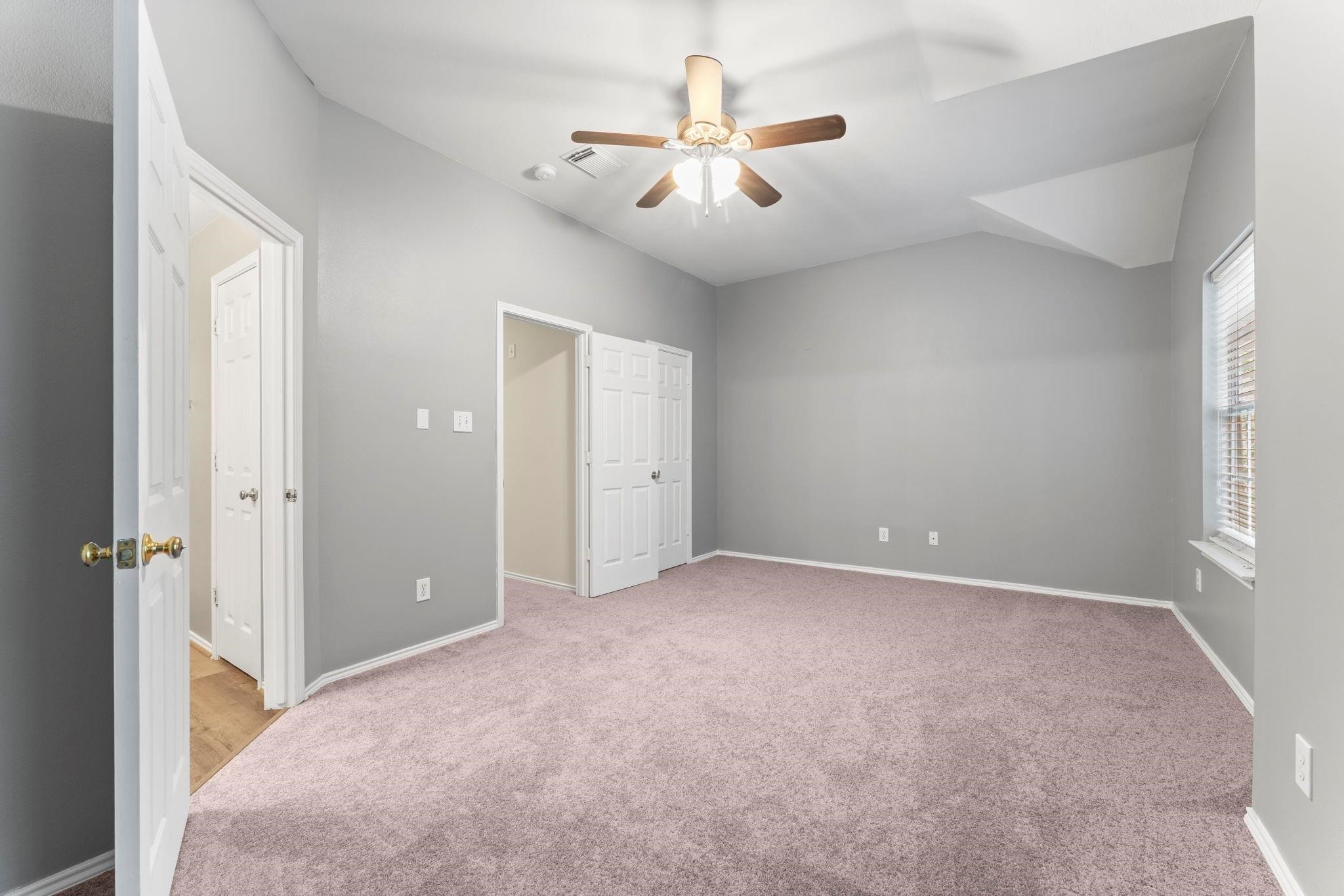 7 Verbena Bend Place Spring, TX 77382 - Photo 14 of 33 an empty room with ceiling fan and window