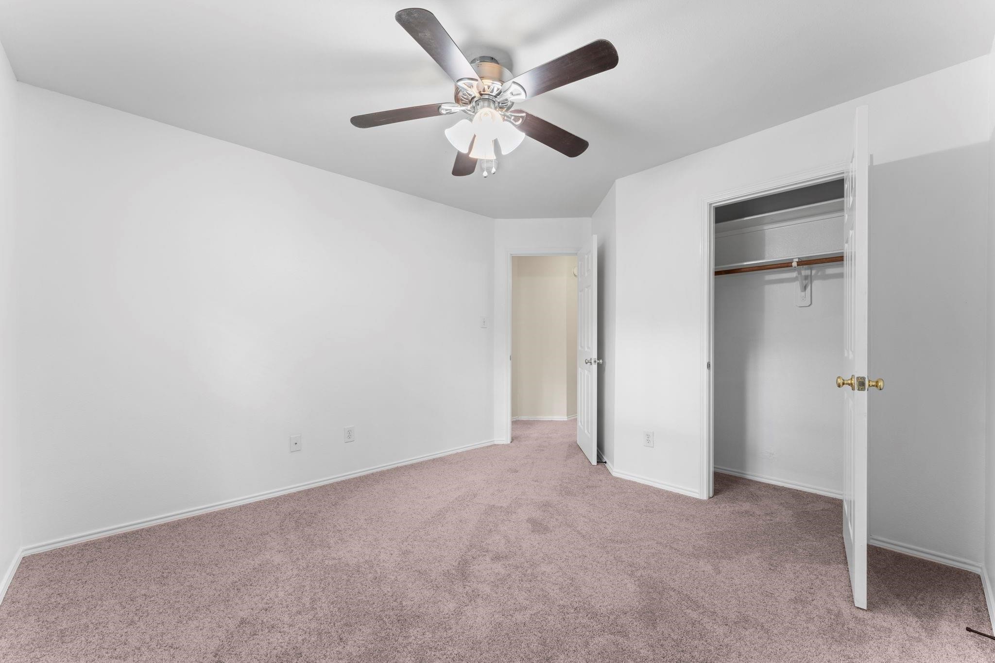 7 Verbena Bend Place Spring, TX 77382 - Photo 20 of 33 an empty room with closet and a ceiling fan