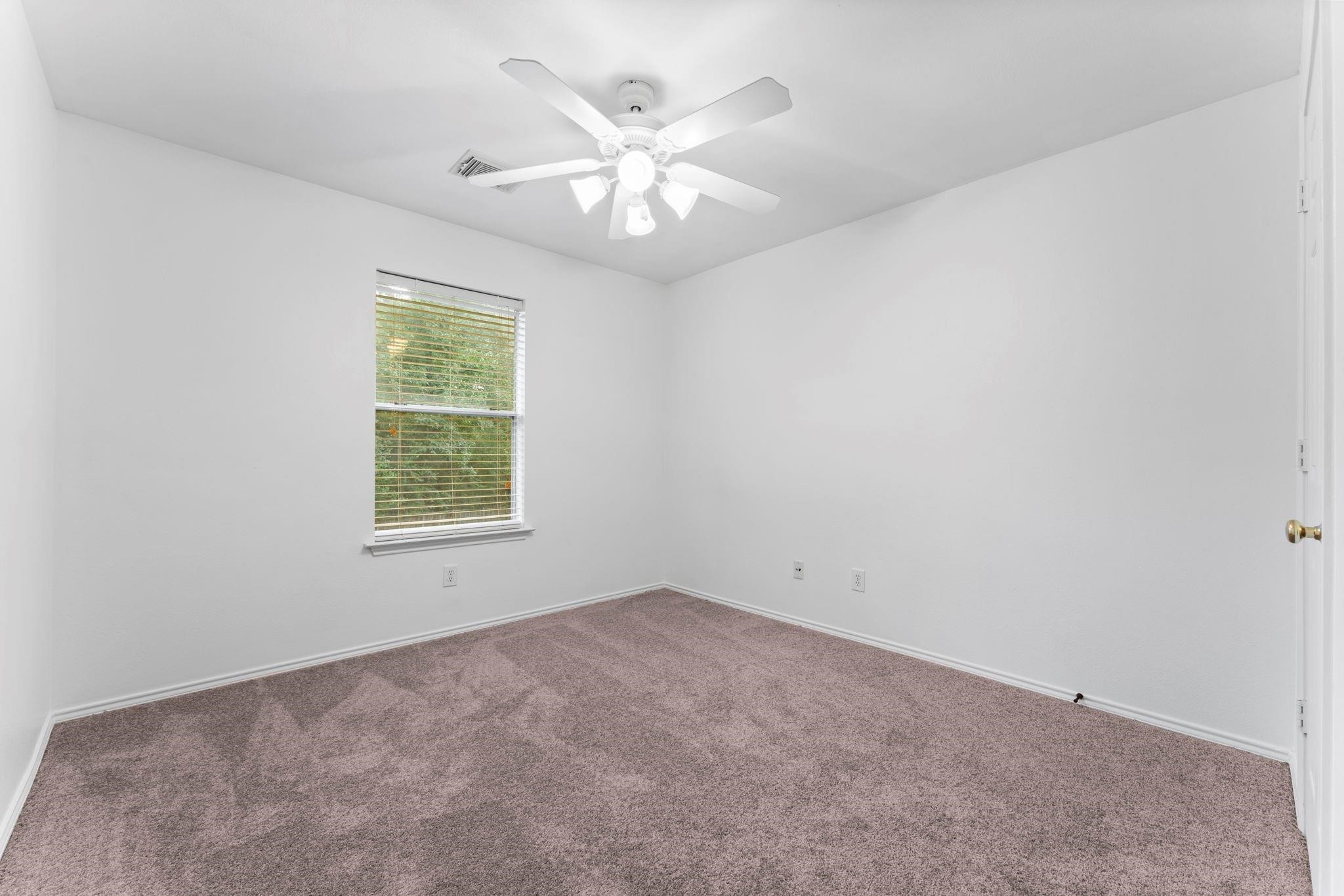 7 Verbena Bend Place Spring, TX 77382 - Photo 21 of 33 an empty room with windows and chandelier fan