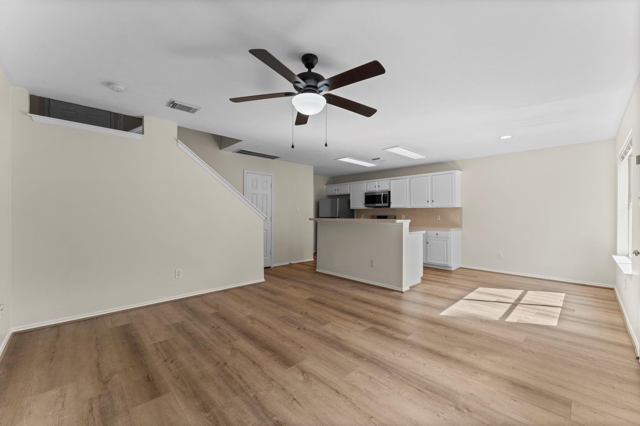 7 Verbena Bend Place Spring, TX 77382 - Photo 6 of 33 a view of kitchen with wooden floor and window