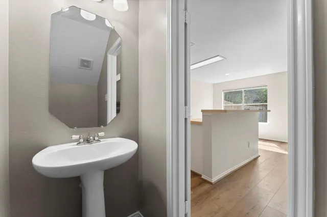 a bathroom with a sink a mirror and a toilet
