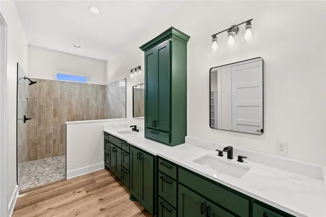 a bathroom with a double vanity sink mirror and shower