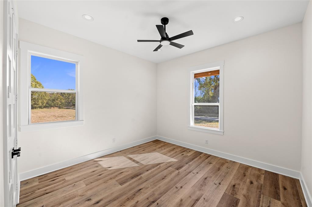1370 County Road 1660 Alba, TX 75410 - Photo 16 of 24 a view of empty room with wooden floor and fan