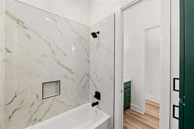 a bathroom with a bathtub and shower