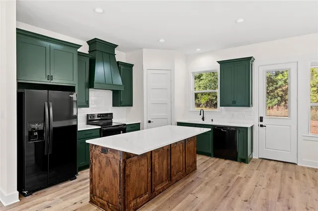 a kitchen with a sink stove and refrigerator