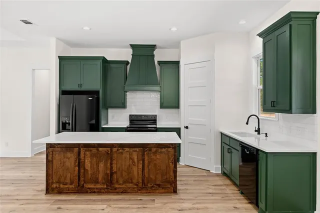 a kitchen with a sink and a refrigerator