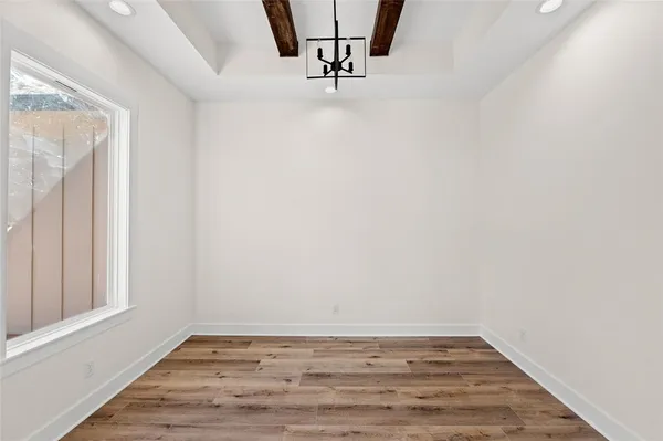 a view of a room with wooden floor and a window