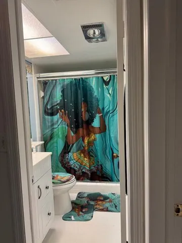 a bathroom with a toilet and a mirror