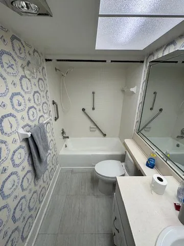 a bathroom with a sink a toilet and bathtub