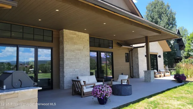 a dining room with furniture a chandelier and window