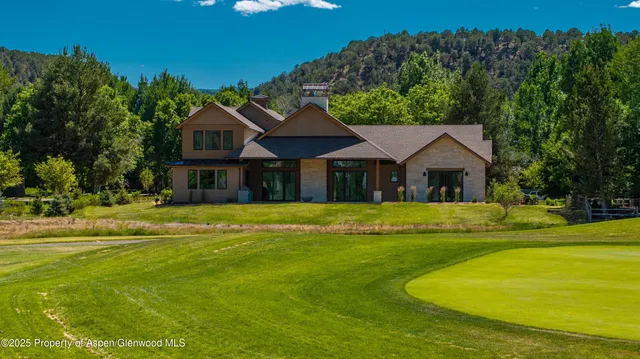a view of a house with backyard porch and sitting area