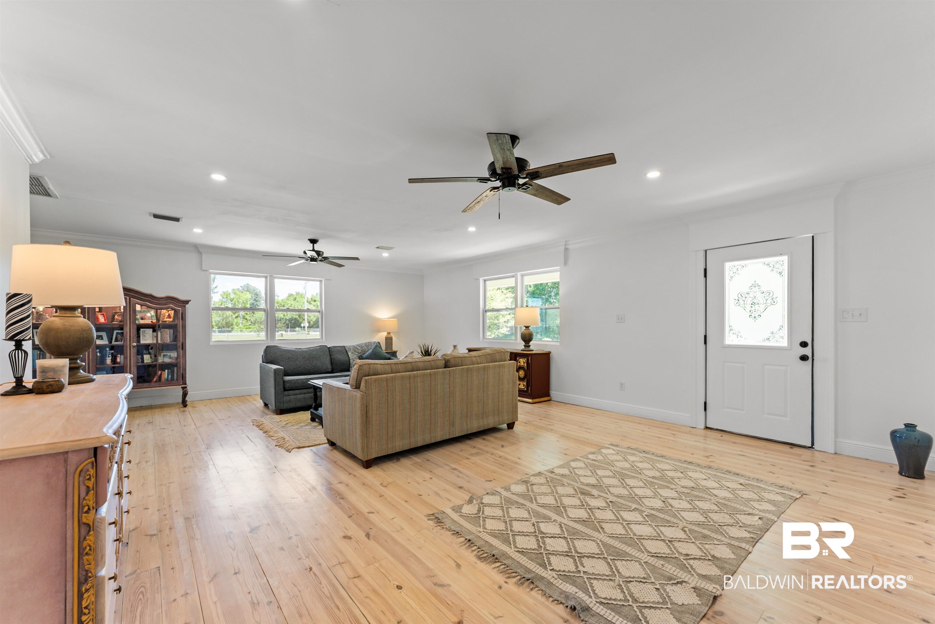 6447 Bemis Lane Bon Secour, AL 36511 - Photo 16 of 62 Bright, open-concept living space featuring wood-finish flooring, recessed lighting, and multiple windows