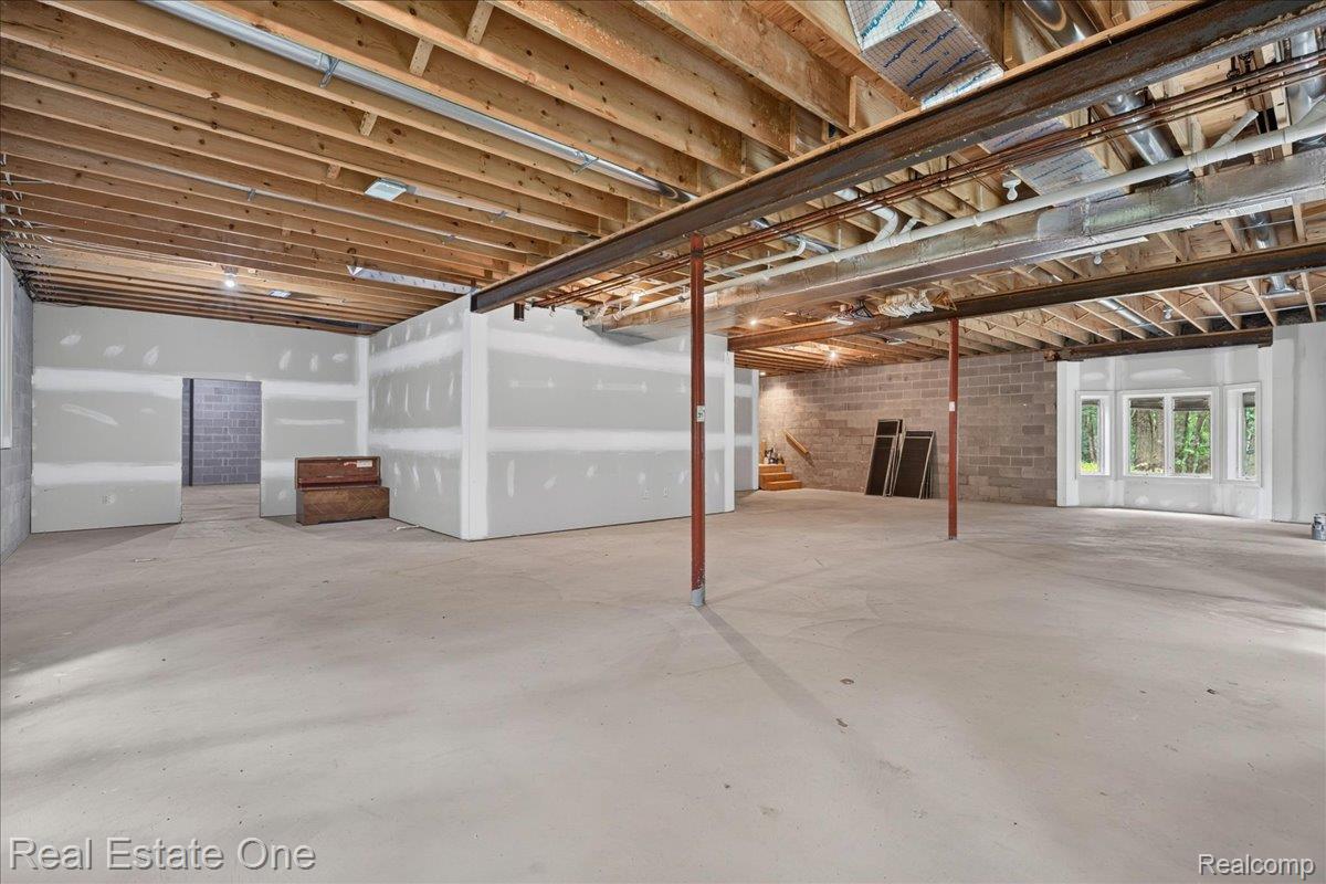 425 Courtney Road Leonard, MI 48367 - Photo 56 of 89 Spacious unfinished basement offering significant customization potential