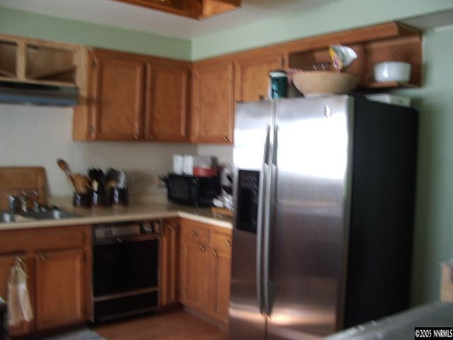 3872 West 7th Street Reno, NV 89503 - Photo 6 of 9 a kitchen with a refrigerator and cabinets