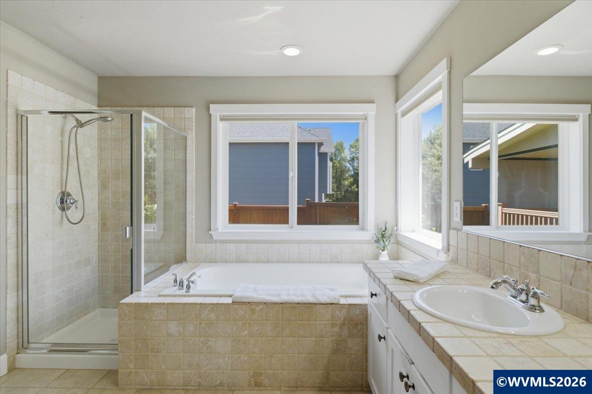 2359 Northwest Gale Street Albany, OR 97321 - Photo 30 of 47 a bathroom with a granite countertop tub sink and mirror