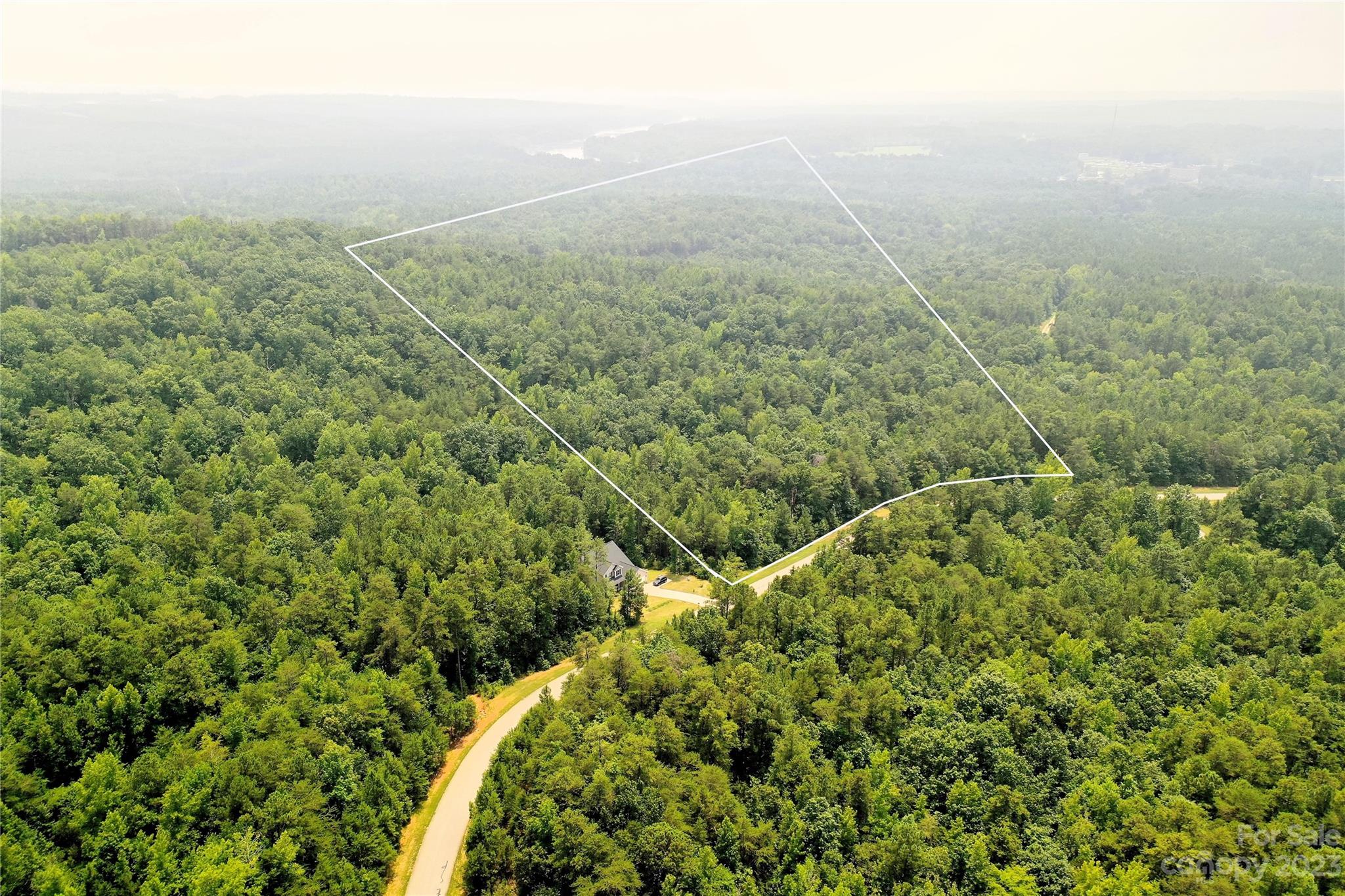 Lot 138 Lennox Loop, Unit 138 Rockingham, NC 28379 - Photo 3 of 18 a view of a field with plants and large trees