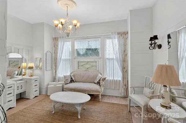 a living room with furniture and a chandelier
