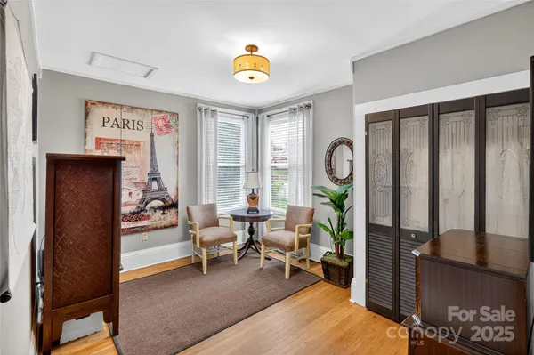a living room with furniture a dining table and a window