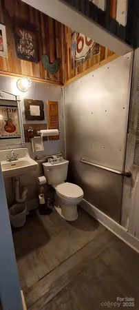 a bathroom with a toilet and a mirror