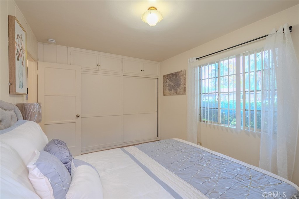 7859 Sycamore Avenue Riverside, CA 92504 - Photo 20 of 31 a bedroom with a bed and a window