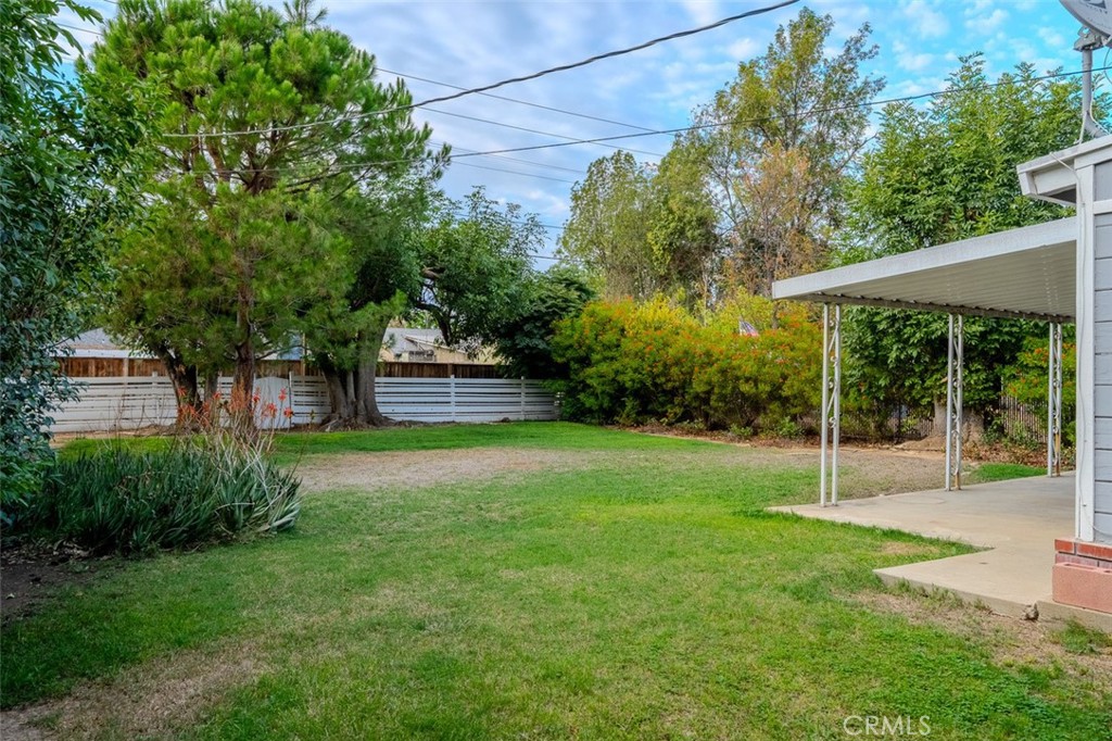 7859 Sycamore Avenue Riverside, CA 92504 - Photo 28 of 31 a view of a house with a backyard and a tree