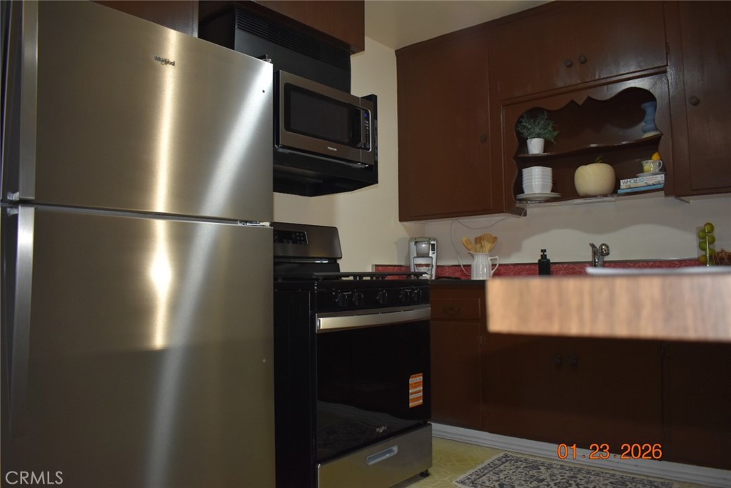 7859 Sycamore Avenue Riverside, CA 92504 - Photo 29 of 31 a kitchen with a refrigerator and a sink