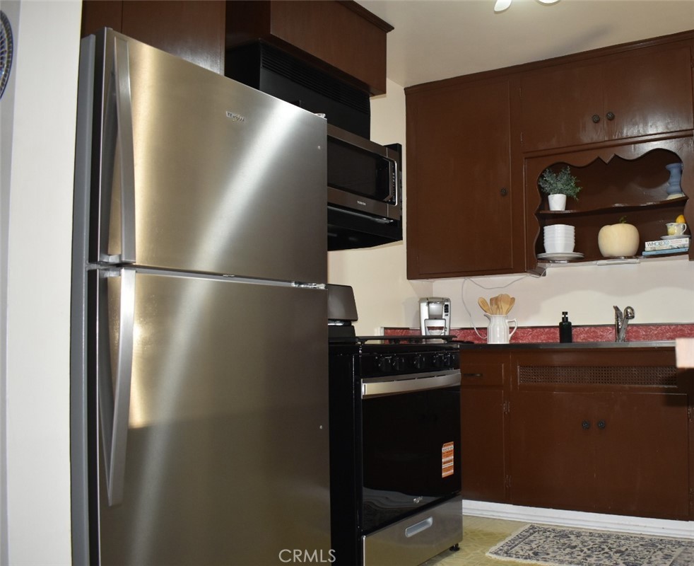 7859 Sycamore Avenue Riverside, CA 92504 - Photo 30 of 31 a kitchen with a refrigerator and a sink