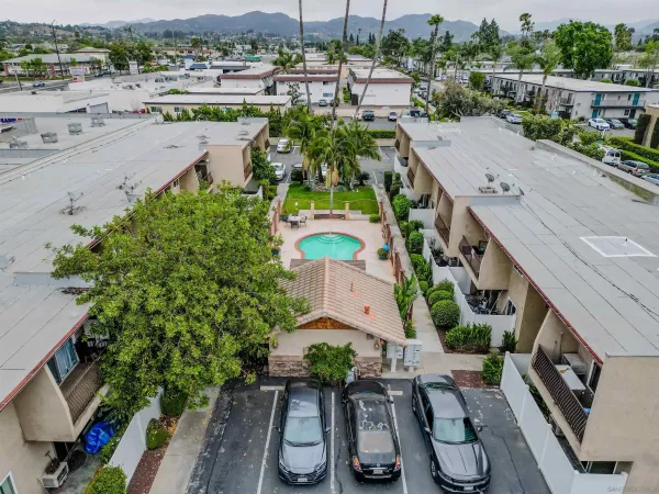 an aerial view of a house with a garden and lake view