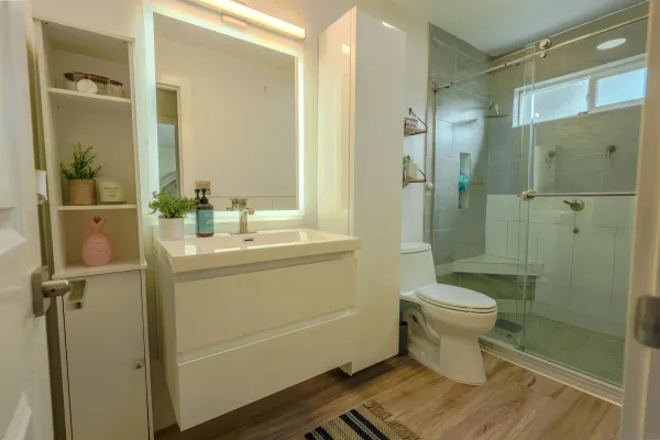a bathroom with a sink toilet and shower