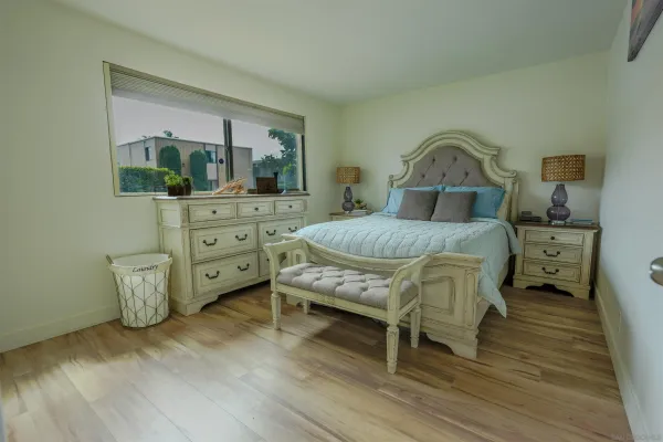 a bedroom with a bed chair and a window