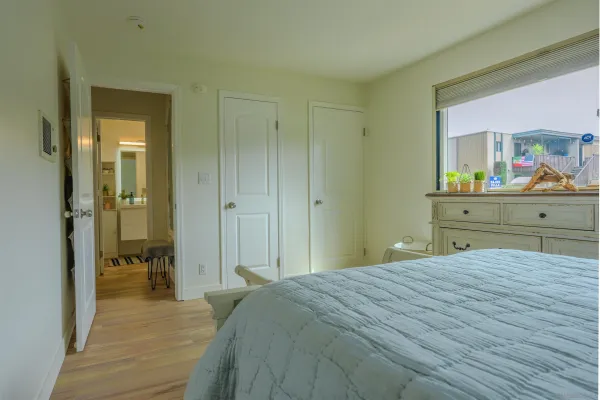 a bedroom with a bed and a mirror