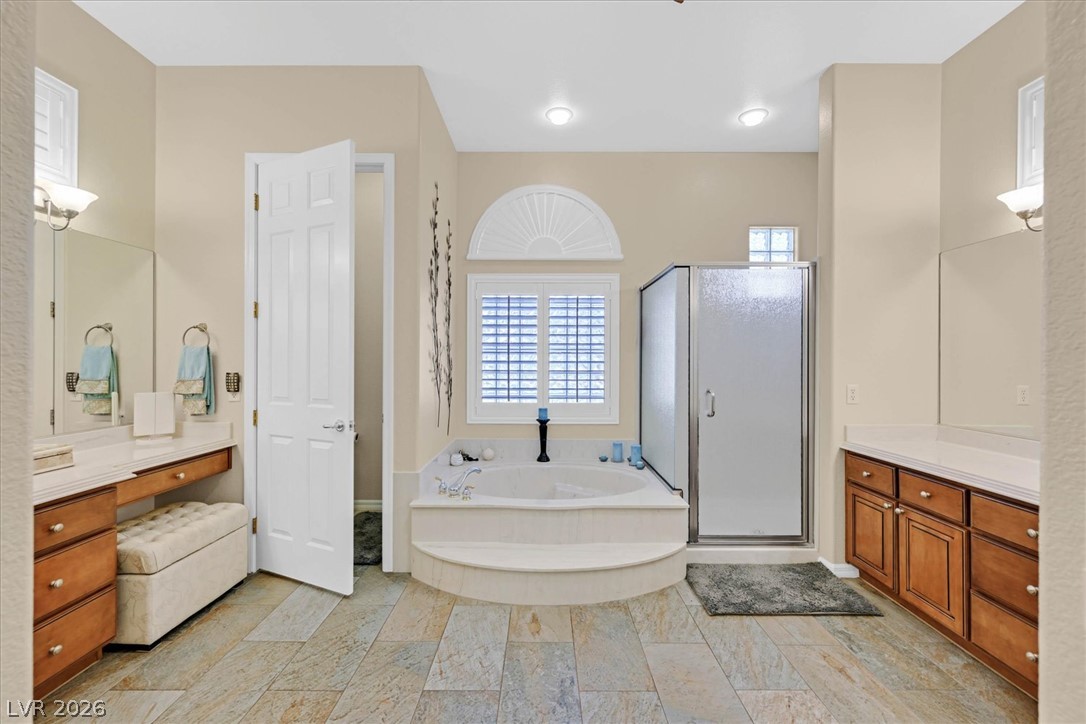 1823 Baton Rouge Street Henderson, NV 89052 - Photo 22 of 60 High ceilings and stone tile flooring highlight this bathroom featuring a built-in soaking tub.