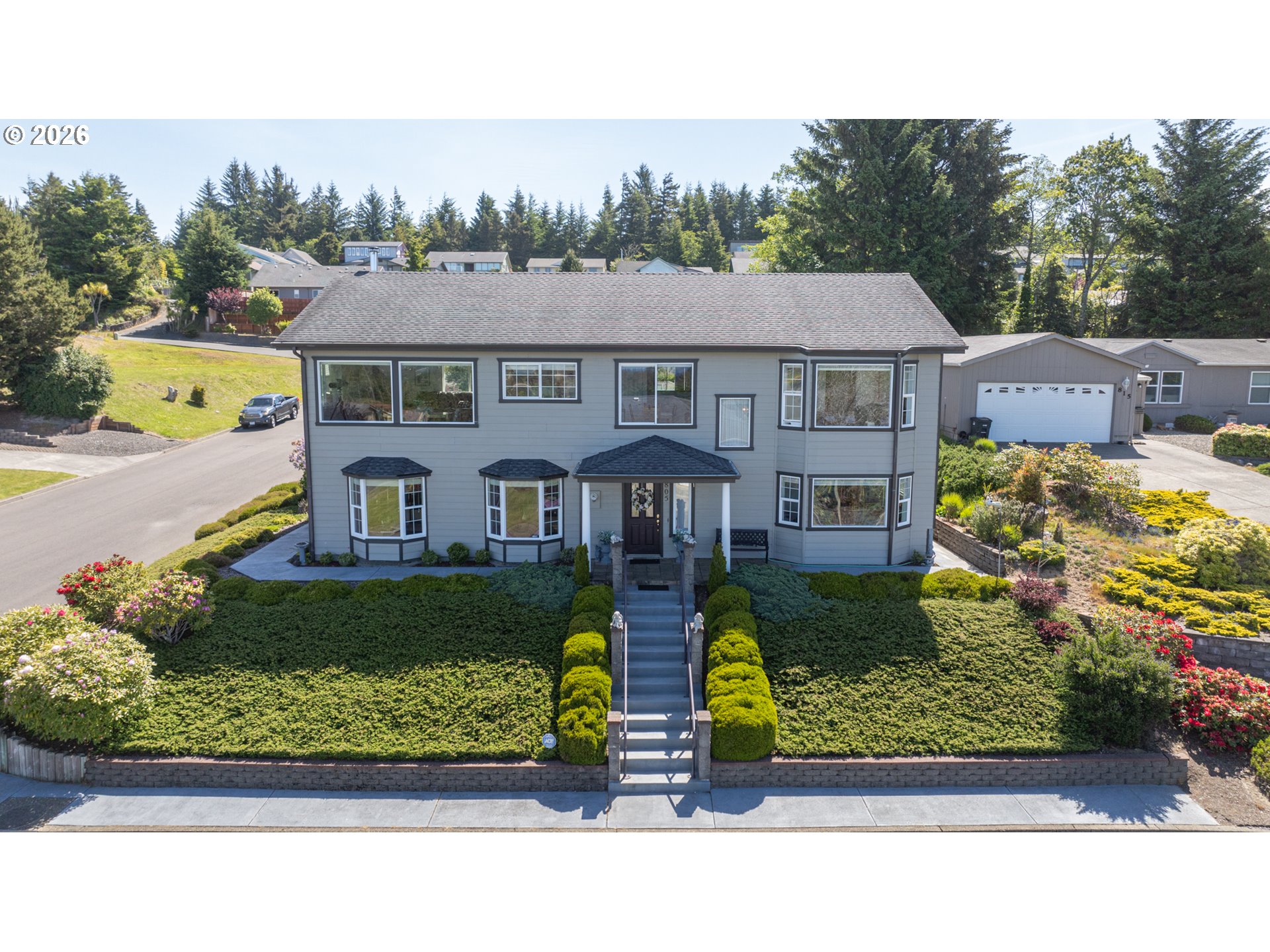 an aerial view of a house with a garden and plants