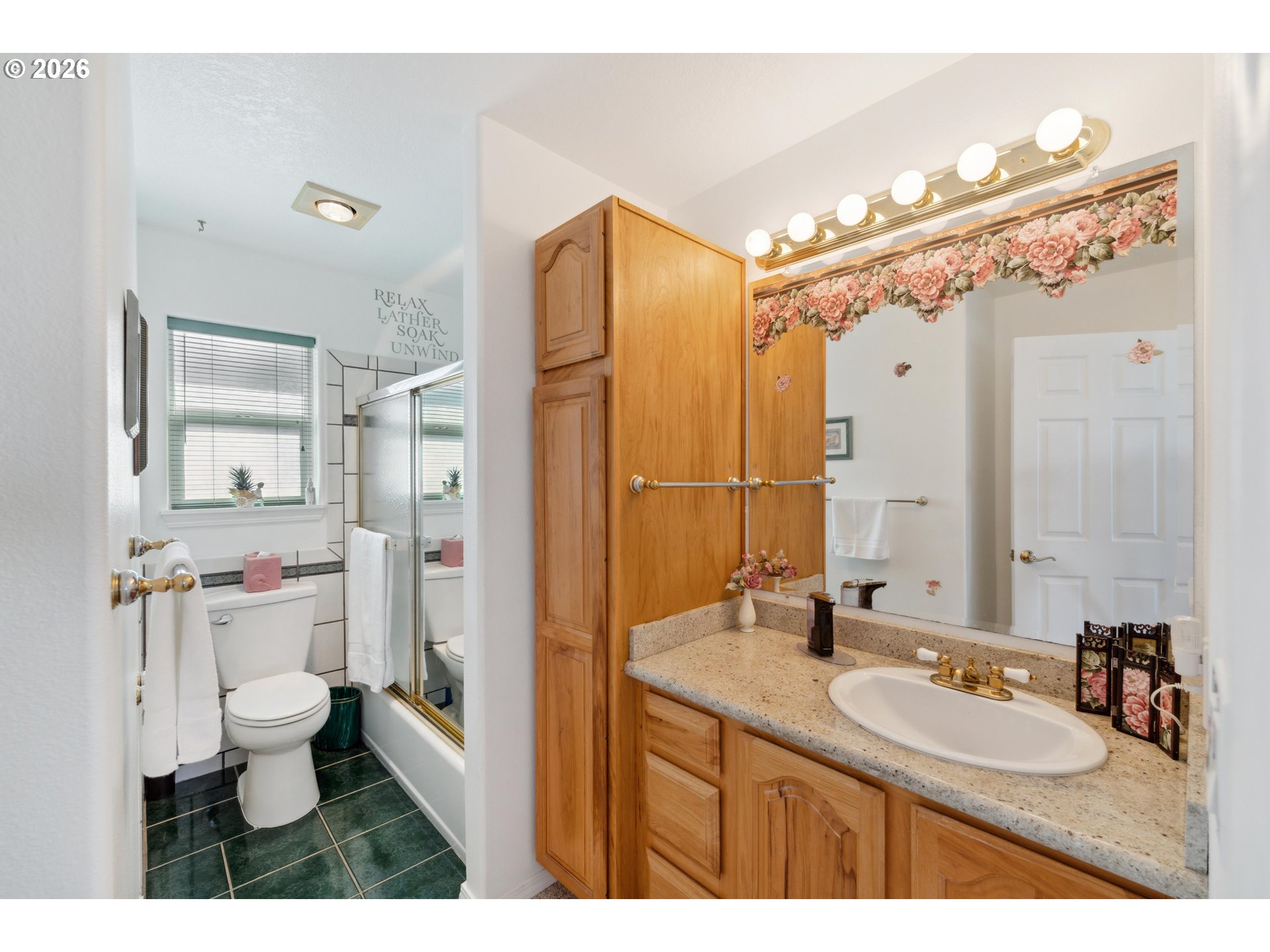 805 Lisa Place Coos Bay, OR 97420 - Photo 22 of 47 a bathroom with a sink a toilet a mirror and shower